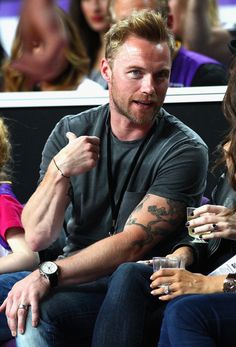 a man sitting next to a woman at a game