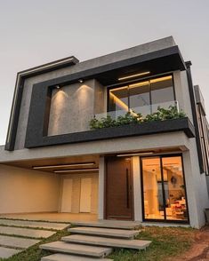 a modern house with plants on the balcony