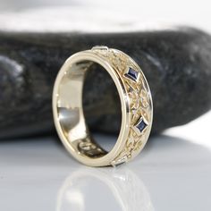 This stunning Celtic wedding ring features princess cut sapphire set gorgeously on the carved Celtic know wedding band. The intricate design makes this ring a perfect choice as a wedding anniversary ring for men and women who are looking for an eye-catching unique wedding ring. Style #R139P-14K-BSAPP • 𝐌𝐞𝐭𝐚𝐥: 𝟏𝟒𝐊 𝐆𝐨𝐥𝐝 • 𝐁𝐚𝐧𝐝 𝐂𝐨𝐥𝐨𝐫𝐬: Rose Gold, Yellow Gold, White Gold Blue Sapphire : *Medium to medium dark blue*Clarity : Natural AAA -Eye Clean*Shape : Princess Cut*Approx. ge Antique Rings Men, Vintage Engagement Rings Men, Mens Engraved Rings, Wedding Ring Ideas Men, Sapphire Engagement Ring Men, Vintage Men Rings, Men’s Wedding Ring With Sapphire, Unique Mens Engagement Rings, Male Rings Wedding