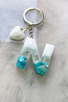 Personalized keychain with a lovely letter made out of resin Classy Keychain, Resin Pendant Diy, Diy Resin Keychain, Lovely Letter, قلادات متدلية, Keychain Craft, Epoxy Resin Diy