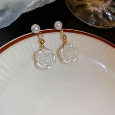 ✦ These stunning earrings feature a delicate floral design, gracefully complemented by lustrous pearls that add a touch of timeless elegance. Crafted precisely, each earring showcases a beautiful flower, symbolizing grace and femininity. The drop style ensures a noticeable yet refined presence, making them perfect for special occasions like weddings or as a statement piece for everyday elegance. These earrings are not only visually appealing but also durable and comfortable for extended wear. Wh Elegant Gothic, Pearl Decor, Nose Rings Hoop, Crystal Hoop Earrings, Elegant Flowers, Stunning Earrings, Fashion Jewelry Earrings, Jewelry Wedding, Bridesmaid Jewelry