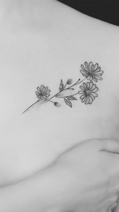 a woman's chest with flowers on it