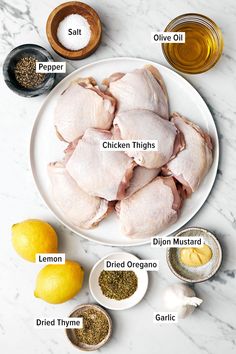 ingredients for chicken thighs on a white plate