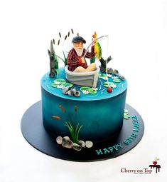 a birthday cake with an image of a man fishing