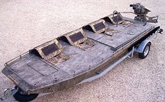 an old boat is parked on gravel with two seats in the front and one out side