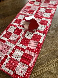 a red and white table runner with a heart on it