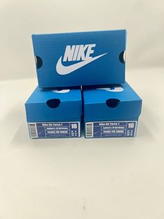 two blue nike boxes stacked on top of each other