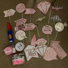 pink and white wedding photo props on the floor with confetti, cake toppers, and candy