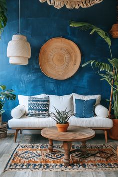 a living room with blue walls and plants on the wall, including a white couch