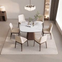 a dining room table with six chairs and a chandelier hanging from the ceiling