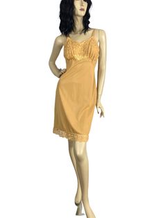 Vintage 60s slip dress in a rich gold shade with beautiful lace bodice. Nice details & a beautiful slip for autumn into the holiday season. Can easily be worn as a dress. - Quality gold nylon fabric - Satin floral applique at underbust - Floral lace bodice lined in sheer chiffon - Tiny lace trim at bodice - Scalloped floral lace trim - Satin straps with adjustable metal hardware - Made in USA LABEL: Seamprufe | 100% Antron Nylon CONDITION: Very Good to Excellent - one repair in side seam near hem done by previous owner (see last photo). Otherwise lovely. SIZE: tagged a 34 (bust) - Small - fits size 4/6 Bust - 33" Waist - 28" Hips - 36" Length - 37" Item # 2892 tags: vintage slip dress, fall fashion, gold slip dress, small vintage Fitted Lace Patchwork Slip Dress For Daywear, Gold Dress With Lace Trim, Gold Lace Dress With Lace Trim, Vintage Lace Slip Dress For Party, Vintage Lace Camisole Dress, Vintage Lace Trim Slip Dress For Party, Slip Dress Fall, Gold Slip Dress, Blue Slip Dress