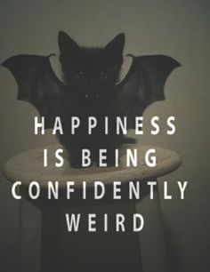 a bat sitting on top of a table with the words happiness is being confidently weird