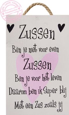 a wooden sign with the words zussen and hearts in pink on white background