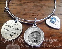 a close up of a bracelet on a table with a baby's face in the center