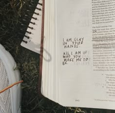 an open book with writing on it sitting in the grass