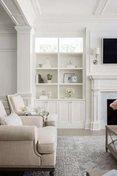 a living room filled with furniture and a flat screen tv mounted on the wall above a fireplace