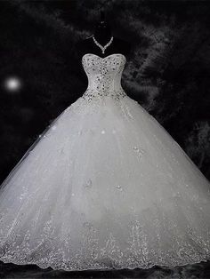 a white ball gown on display in the dark