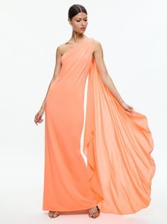 a woman in an orange dress with one shoulder draped over her head and the other side open