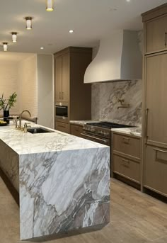 a large kitchen with marble counter tops and wooden cabinets, along with an island in the middle