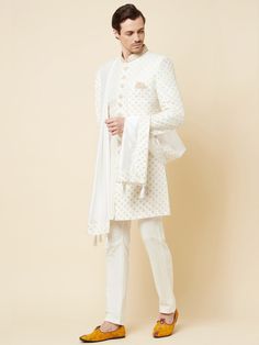 This Royal White Embroidered sherwani will instantly give an elegant look. Made from polyester cotton fabric, this 3 piece sherwani set features a white royal sherwani, front buttons fastening, designer cuff buttons, pocket square, and a mandarin collar. This white base sherwani has beautiful subtle gold Jaal thread-sequin embroidery work all over. It is paired with white churidar pants and matching dupatta. An ideal outfit for traditional & special events.

Size Chart For Men





	
	
					Men' Formal White Nehru Jacket With Straight Kurta Shape, Embroidered Off White Cotton Sherwani, Elegant White Bandhgala Straight Kurta, Embroidered Off-white Cotton Sherwani, Fitted Cotton Sherwani With Traditional Drape, Designer Embroidered Cotton Sherwani, Designer Cotton Fitted Sherwani, Designer Fitted Cotton Sherwani, Designer Cotton Sherwani With Naqshi Detail