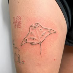 a woman's arm with a tattoo on it that has a drawing of a manta ray