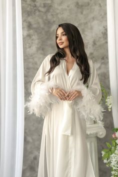 "Long bridal robe is made of high-qualiry silk satin. It has long wide sleeves made of lace and wide belt.  Boa natural  feathers! When you have one of the most important days in your life, everything should be perfect! You probably planned every minute of this day and now you are ready to make it real. The perfect day starts from the very morning which will be remembered every time you will look at your photos.  The bride robe should be beautiful and comfortable at the same time so you could en Luxury Chic Wedding Robe, Champagne Dressing Gown Fluffy Robe, Boudiour Robes, Luxury Elegant Robe For Formal Occasions, Luxury V-neck Wedding Robe, Long Bridal Robe Nordstrom, Luxury Long Sleeve Wedding Robe, Luxury Elegant Cream Robe, Luxury Floor-length Wedding Robe