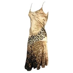 Presenting a stunning beige silk Roberto Cavalli slip dress. From the early 2000s, this gorgeous dress is covered in a tan abstract and leopard print. The dress features a scoop neckline, spaghetti straps, a flared hem, and a draped accent at the back. This sexy is constructed of luxurious silk that perfectly and gently reflects light. Approximate measurements: Size - S Bust: 24-26" Waist: 24" Hips: 28-30" Shoulder to hem: 50" 100% Silk Animal Print Slip Dress, Silk Dress With Leather Jacket, Slip Dress Jacket, Slip Dress Outfit Y2k, 2000 Dresses, Dress Aesthetic Vintage, Dresses 2000s, Vintage Designer Dresses, 2000s Dresses