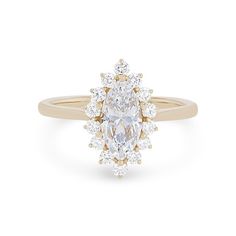 a yellow gold ring with an oval cut diamond surrounded by smaller round diamonds on the band