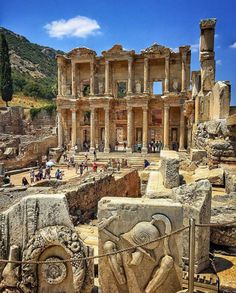 the ruins of an ancient city with people walking around