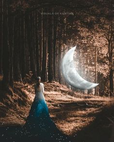 a woman in a blue dress is standing next to the moon