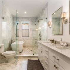 a large bathroom with marble walls and floors