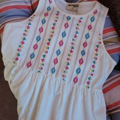 Nwt 100% Soft Cotton Sleeveless Baby Doll Style Top. Embroidered Front, Plain Back. Very Flattering Fit. Hand Wash Cold, Line Dry. Size S (Photo Shows Size M, But I Have Multiple Sizes Avail) White Sleeveless Top With Floral Embroidery, White Floral Embroidered Sleeveless Top, White Sleeveless Embroidered Top, White Sleeveless Embroidered Top For Beach, Sleeveless Top With Multicolor Embroidery For Vacation, Sleeveless Tops With Multicolor Embroidery For Vacation, Sleeveless Multicolor Embroidered Top For Vacation, White Sleeveless Embroidered Top For Summer, Casual White Sleeveless Embroidered Top