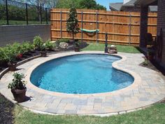 a small backyard with a pool in the middle