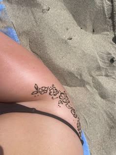 a woman laying on top of a sandy beach