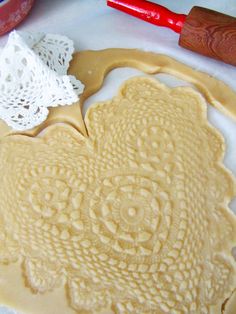 an image of some food being made on the table with crocheted doily