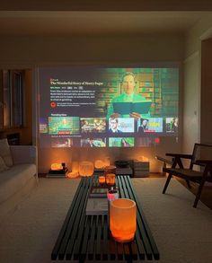 a living room with two couches and a projector screen in the middle of it