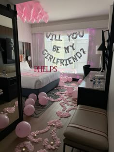 a bedroom decorated with balloons and confetti on the floor in front of a mirror