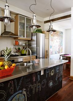 a kitchen with an island and chalkboard on the counter top, surrounded by chairs