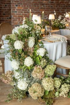 the table is set with flowers and candles