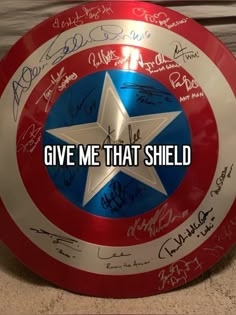 the captain's shield with autographs on it is shown in front of a sign that says give me that shield