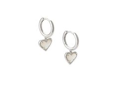 Kendra Scott Ari Heart Huggie Earrings - Earring : Rhodium Ivory Mother-of-Pearl : The Kendra Scott Ari Heart Huggie Earrings are a beautiful hoop with prong-set stone heart pendants. Please refer to color selection for stone detail. 14K gold, 14K rose gold, or rhodium - all plated over brass. Lever back closure. Imported. Measurements: Width: 4 7 in Height: 11 13 in Drop: 2 5 in Weight: 0.1 oz Elegant Sterling Silver Huggie Earrings With Heart Charm, White Gold Huggie Jewelry For Valentine's Day, Valentine's Day White Gold Huggie Jewelry, Silver Elegant Huggie Earrings With Heart Charm, Elegant Silver Huggie Earrings With Heart Charm, Elegant Double Heart Huggie Earrings With Heart Charm, Elegant Sterling Silver Heart Huggie Earrings, Elegant Heart-shaped Sterling Silver Huggie Earrings, Silver Huggie Earrings For Valentine's Day Elegant Style