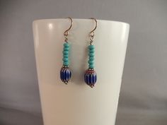 These earrings feature tiny wood beads in turquoise, plus a glass bead of dark blue, white and reddish brown in a chevron pattern. Hook style ear wire is silver-plated,nickel free and hypoallergenic. the earring are 1 and 1/2 inches long. Great for anyone who loves jewelry with a southwestern vibe. Southwestern Blue Beaded Earrings With Round Beads, Southwestern Blue Earrings With Ear Wire, Bohemian Blue Beaded Hypoallergenic Earrings, Bohemian Blue Hypoallergenic Beaded Earrings, Nickel-free Blue Southwestern Earrings, Southwestern Style Blue Beaded Earrings, Blue Bohemian Beaded Sterling Silver Earrings, Bohemian Blue Beaded Sterling Silver Earrings, White Gemstone Necklace