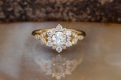 a close up of a diamond ring on a table