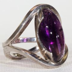 Formal Purple Cabochon Amethyst Ring, Modern Oval Jewelry With Polished Edges, Formal Purple Cabochon Gemstones, Formal Purple Cabochon Ring, Classic Sterling Silver Polished Gemstones, Modern Amethyst Ring With Bezel Setting, Collectible Oval Cabochon Amethyst Ring, Modern Jewelry With Stone Setting, Modernist Formal Cabochon Rings