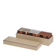 a set of three wooden blocks sitting on top of a metal shelf next to each other