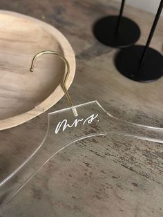 a clear acrylic sign sitting on top of a wooden table