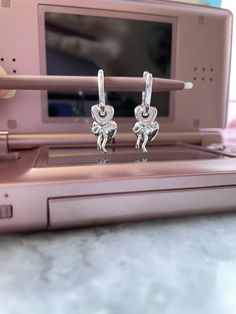 The Kyara hoops catch all your favorite 925 charms in a single place! Curly bow charm, hollow and solid heart charms stacked in perfection, made with 925 sterling silver material: 925 sterling silver measurements: 12mm X 26mm