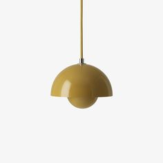 a yellow pendant light hanging from a ceiling