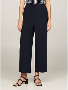 Tommy Hilfiger women's pant. These versatile cropped wide-leg pants work for the office and the hours beyond. The flat-front waistband offers a smooth silhouette, while the elastic band at the back offers comfort and the perfect fit.  Material: 72% Recycled Polyester (rpe). Tailored Ankle-length Wide Leg Pants, Relaxed Fit Wide-leg Dress Pants For Workwear, Chic Cropped Leg Bottoms For Work, Classic Cropped Leg Dress Pants For Work, Classic Cropped Dress Pants For Workwear, Cropped Wide Leg Pants With Welt Pockets For Work, Spring Formal Wide Leg Culottes, Chic Cropped Leg Dress Pants For Office, Workwear Straight Culottes With Pockets