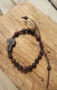 +.God Bless You. +. This is a Wooden Rosary Bracelet. +. It is knotted bracelet and it is adjustable . +. The crufix is carved in elevorate and three dementional shape. +. Beads are more beautiful because they are carved with jujube trees. +.+.+.+.+. Materials +.+.+.+.+.+. Cross: Mpingo (African black wood) beads : jujube tree carved rose wood +.+.+.+.+. Size +.+.+.+.+. Cross : 12mm(Width) *18mm(Height) Beads: 6mm +. Carved characters(e.g. baptismal name, name,etc) on back side +. please send me Adjustable Wooden Beads Spiritual Rosary, Adjustable Wooden Beads Rosary Bracelet Gift, Adjustable Wooden Bead Rosary Bracelet Gift, Adjustable Crucifix Jewelry With Wooden Beads, Adjustable Wooden Bead Crucifix Jewelry, Spiritual Brown Rosary Bracelet With Cross, Adjustable Brown Spiritual Rosary, Adjustable Brown Wooden Beads Rosary Bracelet, Adjustable Brown Hand-strung Rosary